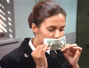 Diana Prince kisses a 2 dollar bill.